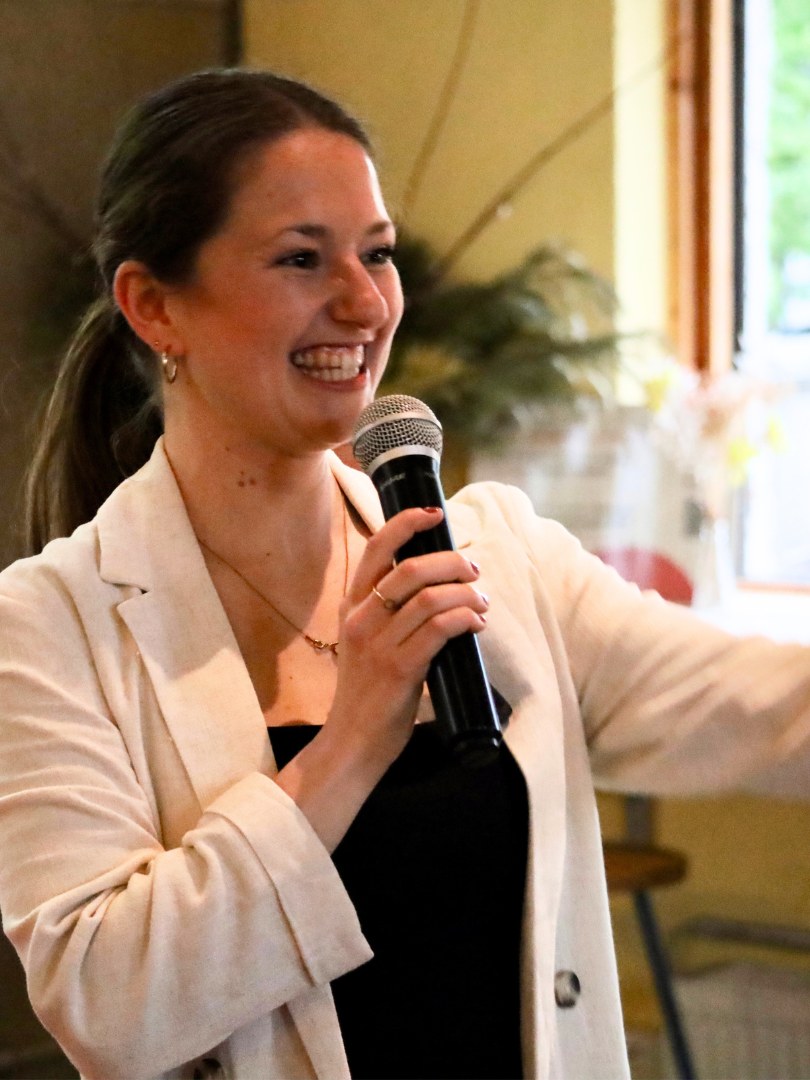 Karina Indytska smiling while speaking with a microphone
