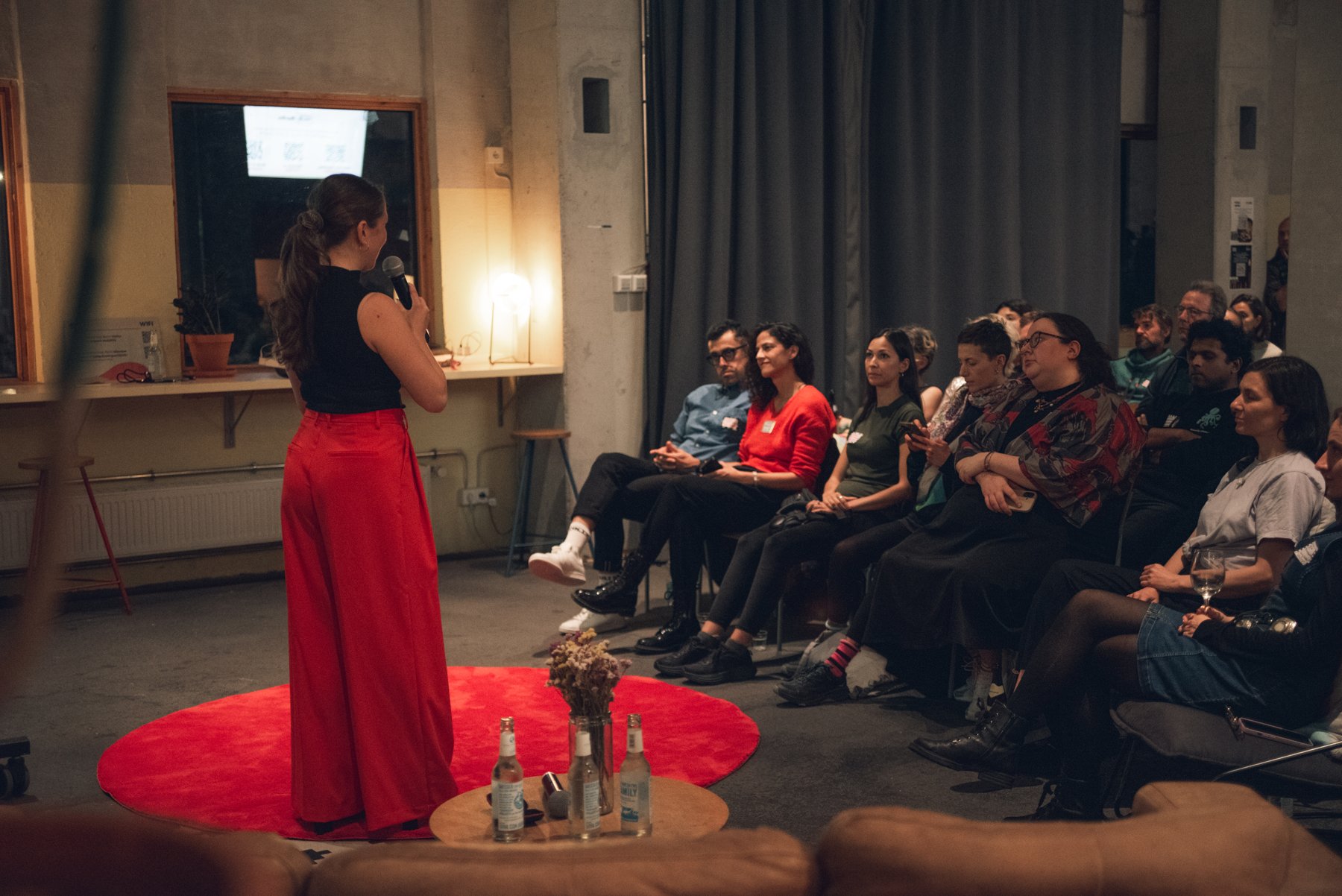 Karina Indytska speaking on stage to an engaged audience